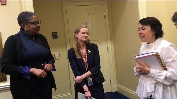 A legislator and her staff listen to a constituent discuss a concern about a bill.